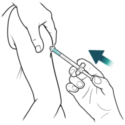 Thumb pushing syringe plunger down.
