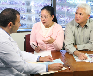 Woman and man talking to health care provider.