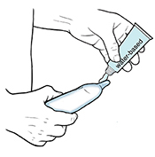 Water-based lubricant being put on condom on erect penis.