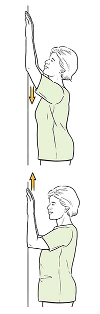 Woman doing wall climb exercise.