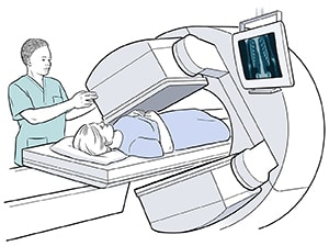 Person lying on table underneath scanner and health care provider adjusting scanner.